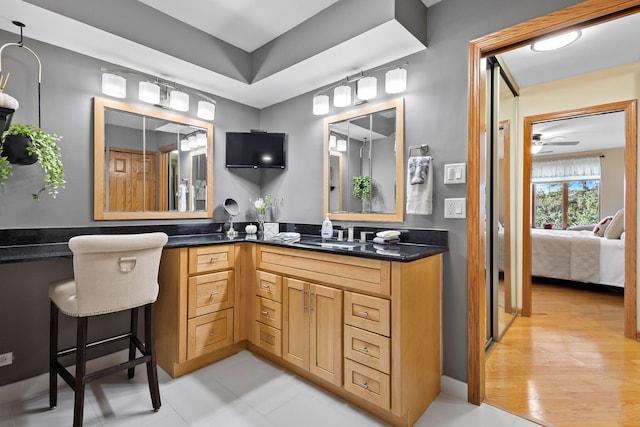 bathroom with vanity, ceiling fan, and hardwood / wood-style floors