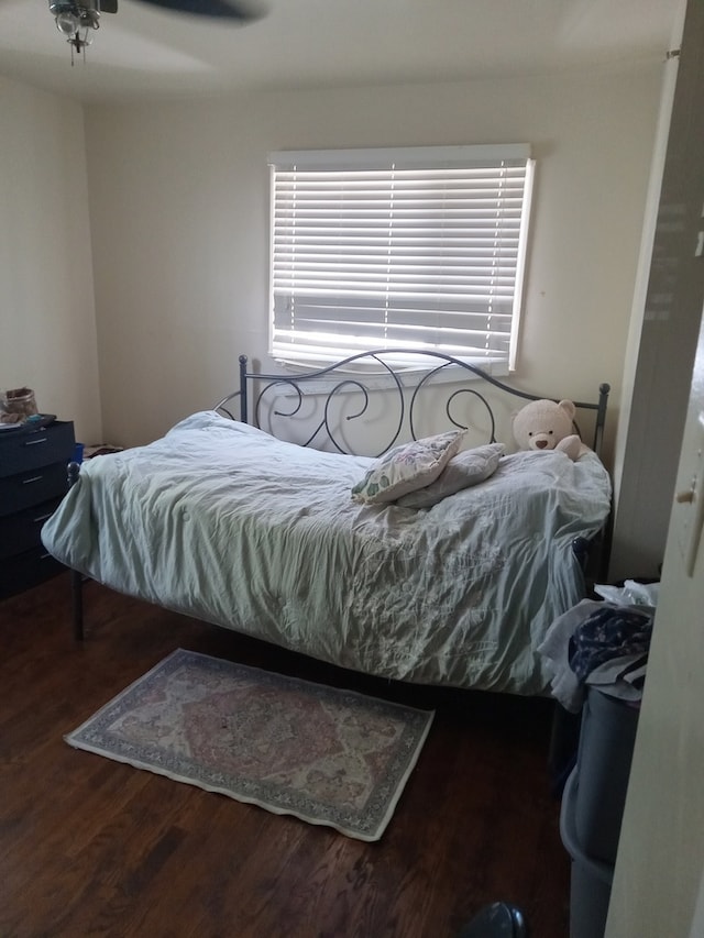 bedroom with ceiling fan and dark wood-type flooring