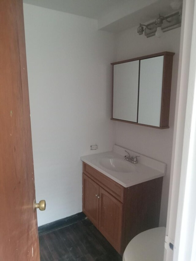 bathroom with vanity, toilet, and a healthy amount of sunlight