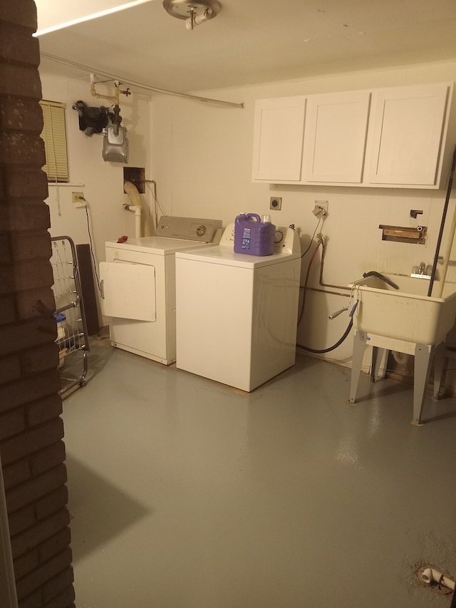 laundry area featuring separate washer and dryer, sink, and cabinets