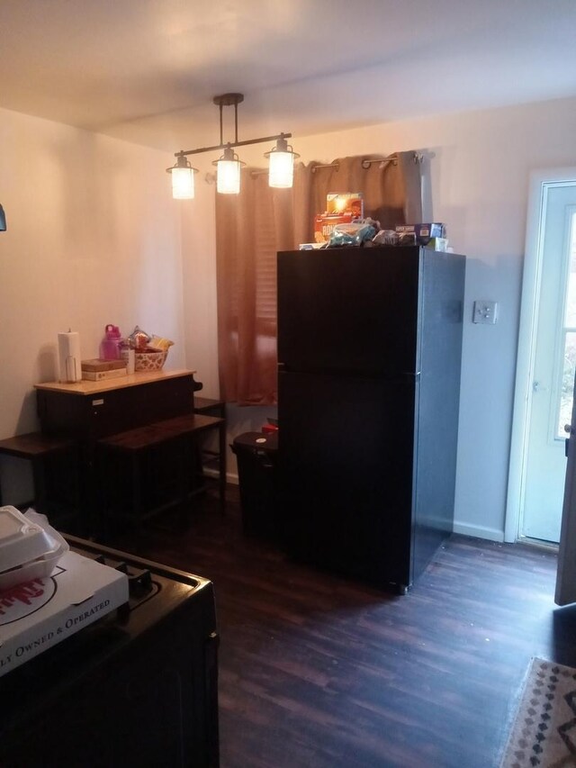 kitchen with gas stove, white cabinetry, and sink