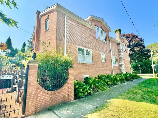 view of side of home featuring a lawn