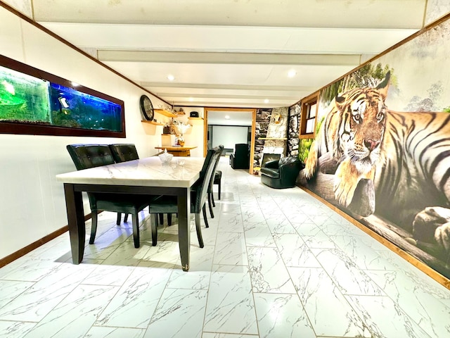 dining area featuring beam ceiling