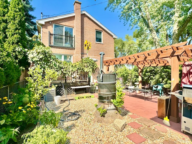 rear view of property featuring a patio area and a pergola