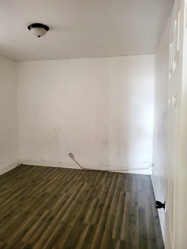 empty room featuring dark wood-type flooring