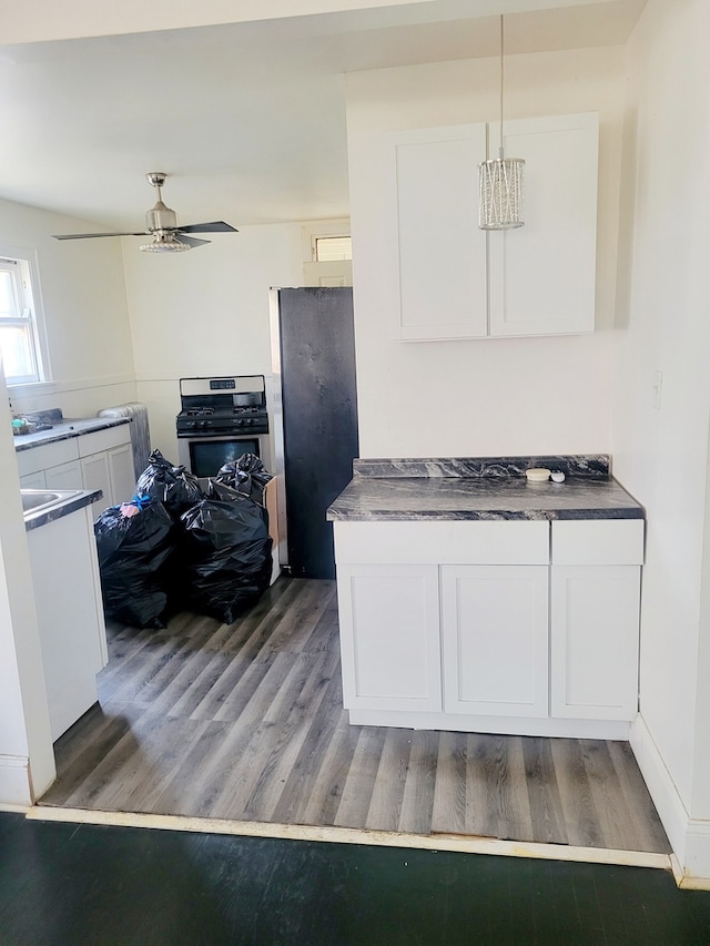 kitchen featuring white cabinets, refrigerator, and dark hardwood / wood-style flooring