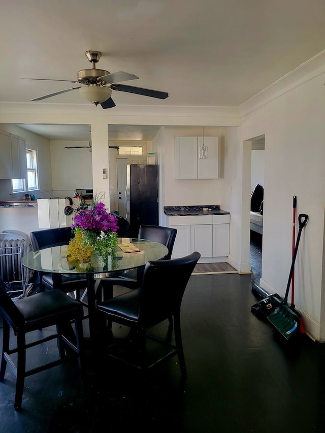 dining space featuring ornamental molding and ceiling fan