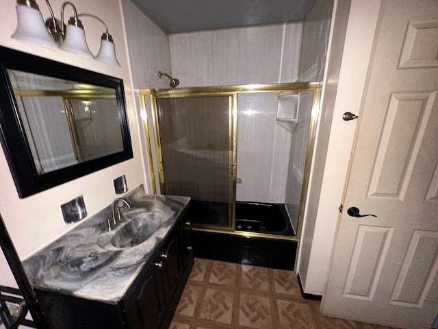 bathroom featuring vanity and enclosed tub / shower combo