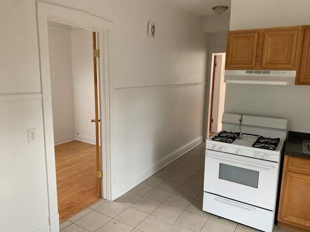 kitchen with white range with gas cooktop and light wood-type flooring