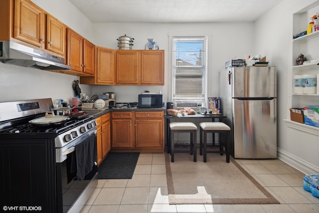 kitchen featuring appliances with stainless steel finishes and light tile patterned flooring