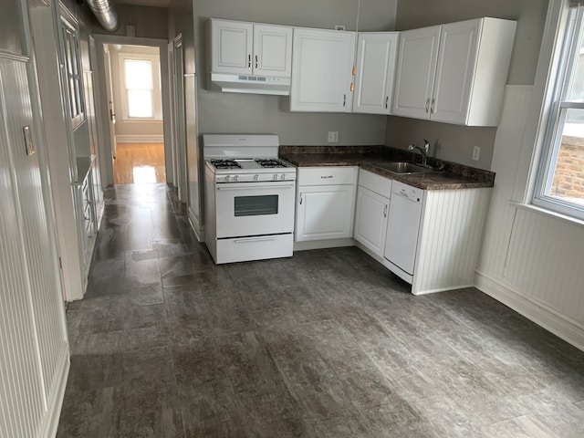 kitchen with white cabinets, a healthy amount of sunlight, sink, and white appliances