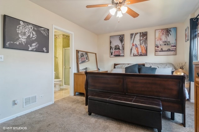 bedroom featuring connected bathroom, light colored carpet, and ceiling fan