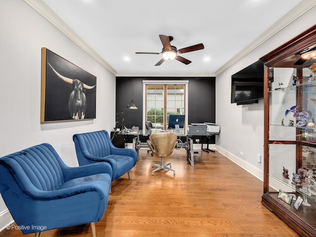 office featuring ornamental molding, light wood-type flooring, and ceiling fan