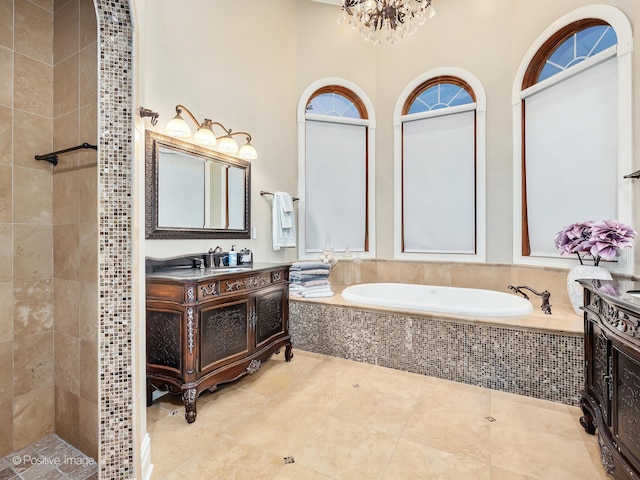 bathroom with vanity, tile patterned floors, independent shower and bath, and a chandelier