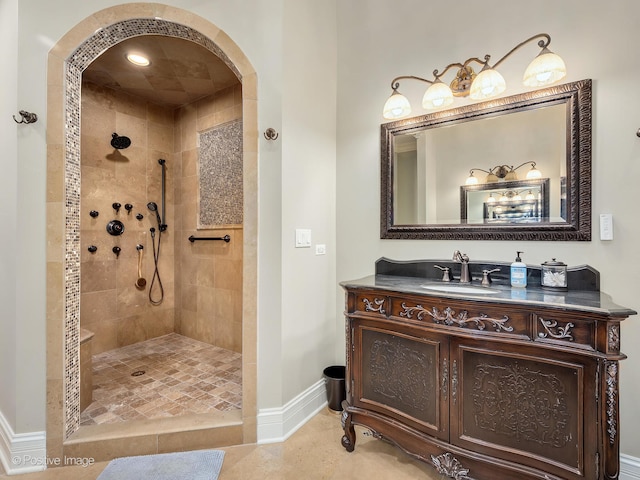 bathroom with vanity, tile patterned floors, and tiled shower