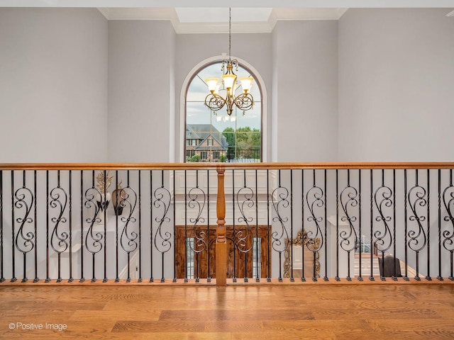 details featuring hardwood / wood-style floors, crown molding, and an inviting chandelier