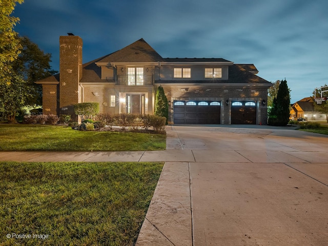 view of front of property featuring a front lawn and a garage