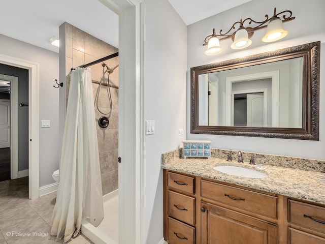 bathroom with vanity, toilet, walk in shower, and tile patterned flooring