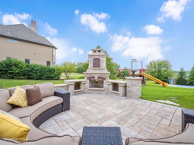 view of patio / terrace featuring a playground and an outdoor stone fireplace