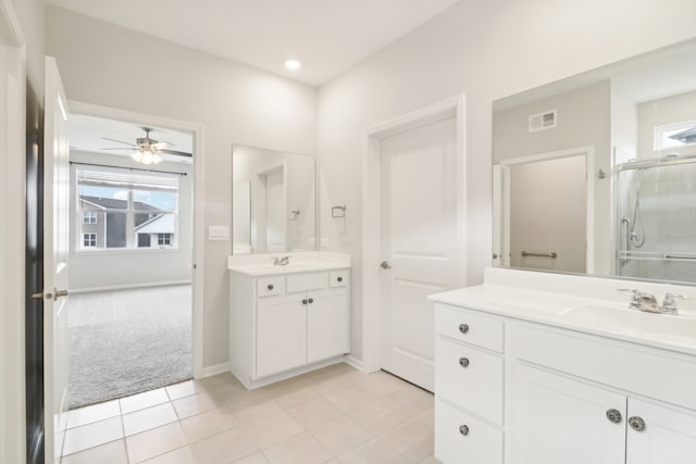 bathroom featuring a shower with door, ceiling fan, tile patterned flooring, and vanity