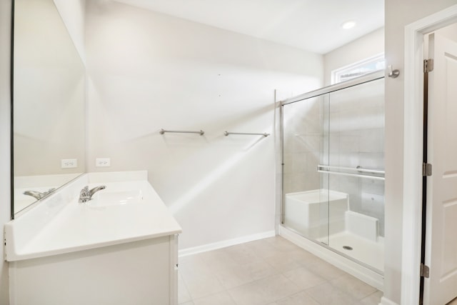 bathroom featuring vanity and an enclosed shower