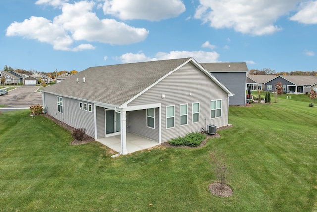 back of house with a patio, central AC, and a yard