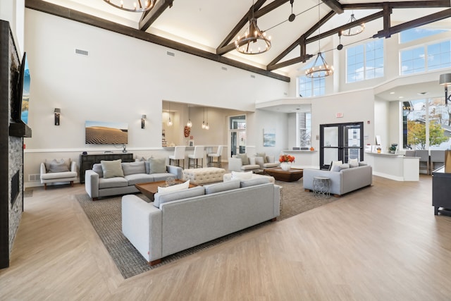 living room with french doors, high vaulted ceiling, wood-type flooring, and beamed ceiling