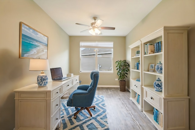 home office featuring light wood-type flooring and ceiling fan