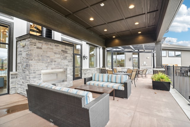 view of patio / terrace with an outdoor living space with a fireplace