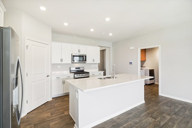 kitchen featuring white cabinets, stainless steel appliances, sink, and a kitchen island with sink