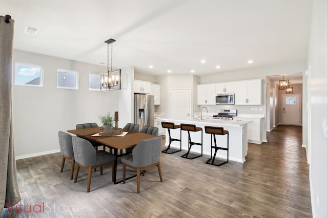 dining area with sink and wood-type flooring