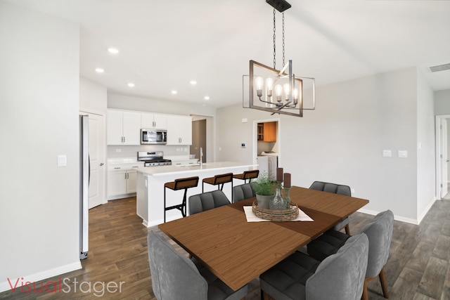 dining area with a chandelier and dark hardwood / wood-style flooring