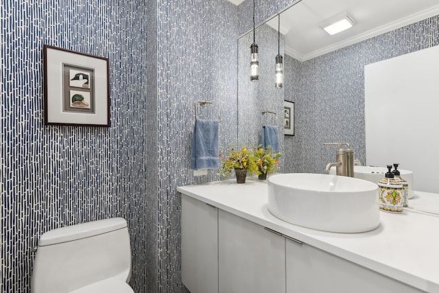 bathroom with vanity, ornamental molding, and toilet