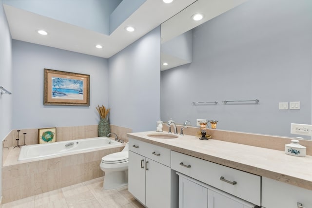 bathroom with toilet, vanity, and tiled bath