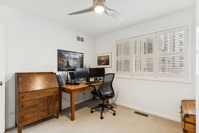 office space featuring light carpet and ceiling fan