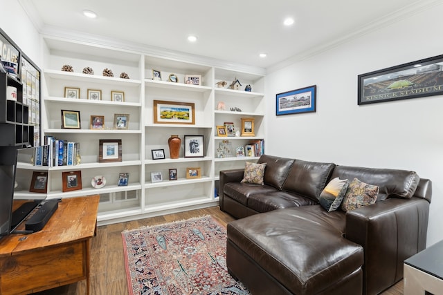 interior space with ornamental molding, hardwood / wood-style floors, and built in shelves