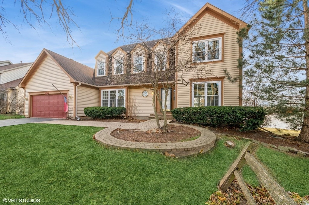 view of front of property featuring a garage and a front yard