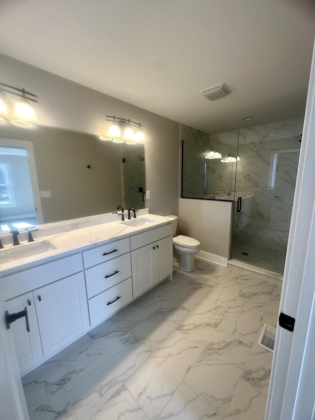 bathroom featuring vanity, a shower with door, and toilet