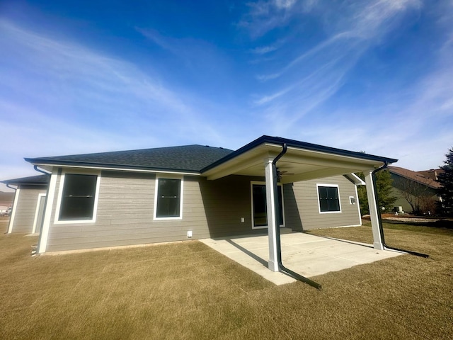 rear view of property with a patio area and a lawn