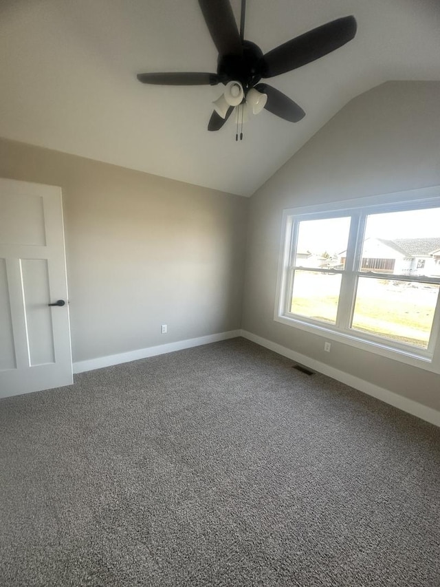 spare room with lofted ceiling, ceiling fan, and carpet