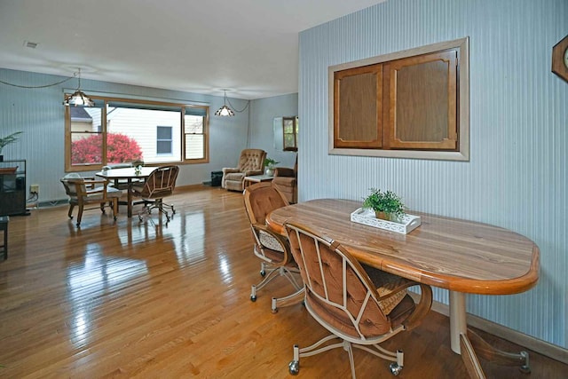 dining space with light hardwood / wood-style floors