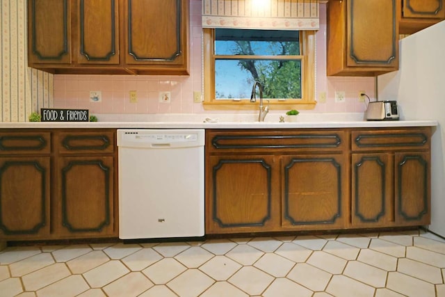 kitchen with sink, white appliances, and backsplash