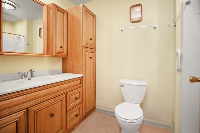 bathroom featuring walk in shower, vanity, and toilet