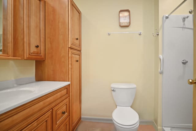 bathroom featuring a shower, vanity, and toilet