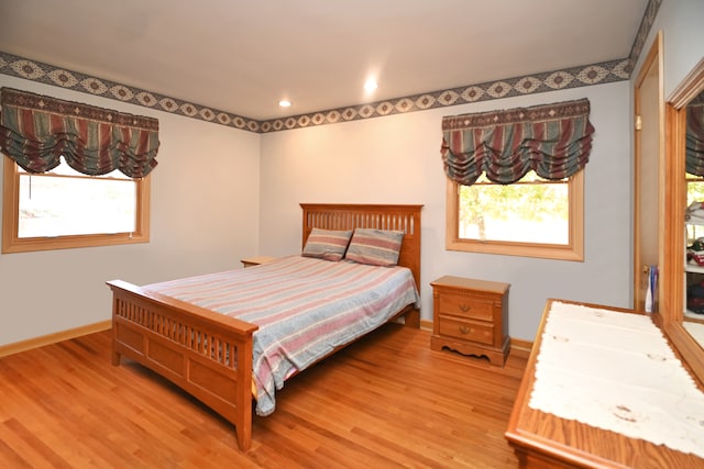 bedroom featuring hardwood / wood-style flooring and multiple windows