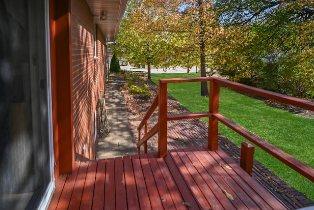 wooden deck featuring a lawn