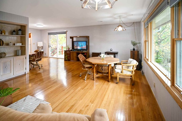 dining area featuring light hardwood / wood-style flooring and a notable chandelier