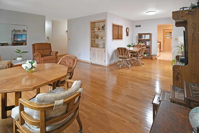 dining area featuring built in features and light hardwood / wood-style flooring