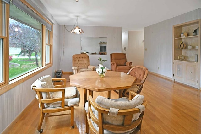 dining area with a healthy amount of sunlight and light hardwood / wood-style flooring