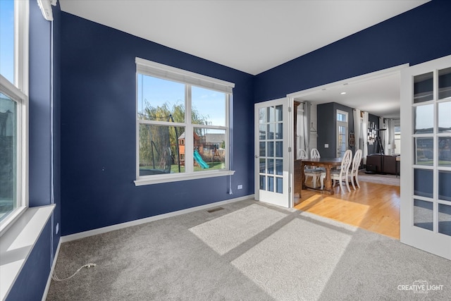 empty room featuring french doors and hardwood / wood-style flooring